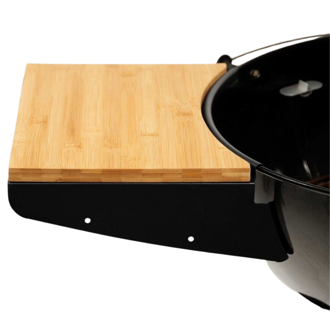Metal shelf fitted to side of Weber 22" Kettle and bamboo board on top of the shelf.